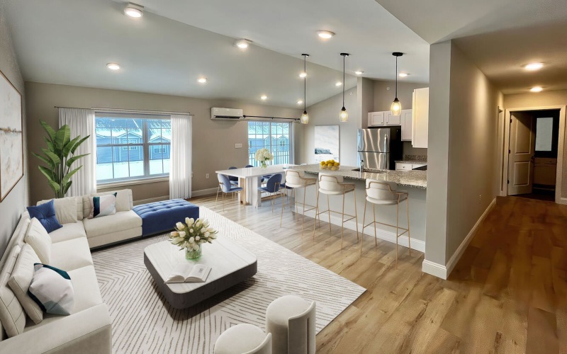 living room with couch coffee table windows and kitchen in view