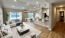 living room with couch coffee table windows and kitchen in view