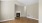 a room with a wood floor and a fireplace