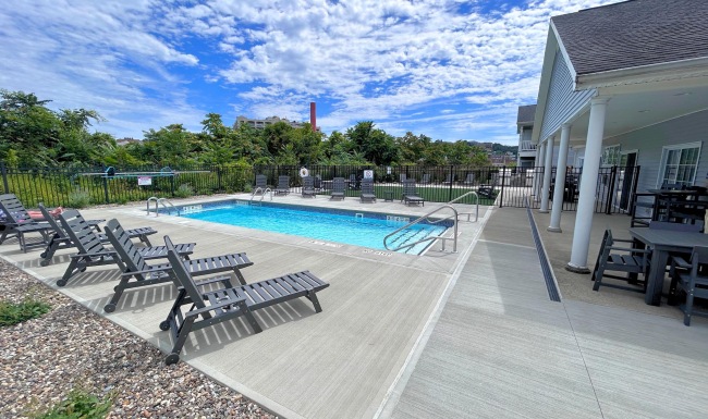 Relax and unwind poolside resort style pool with seating